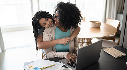 mother and daughter using a laptop